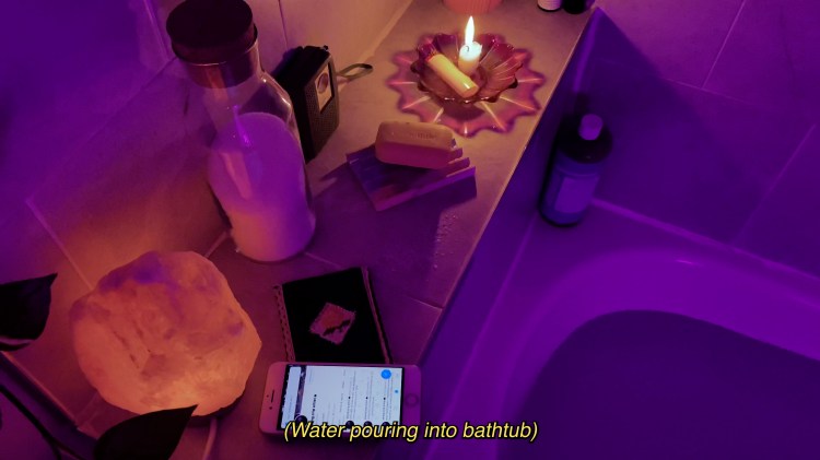 Purple light casts over bathtub half filled with water and caption that reads "(Water pouring into bathtub)"