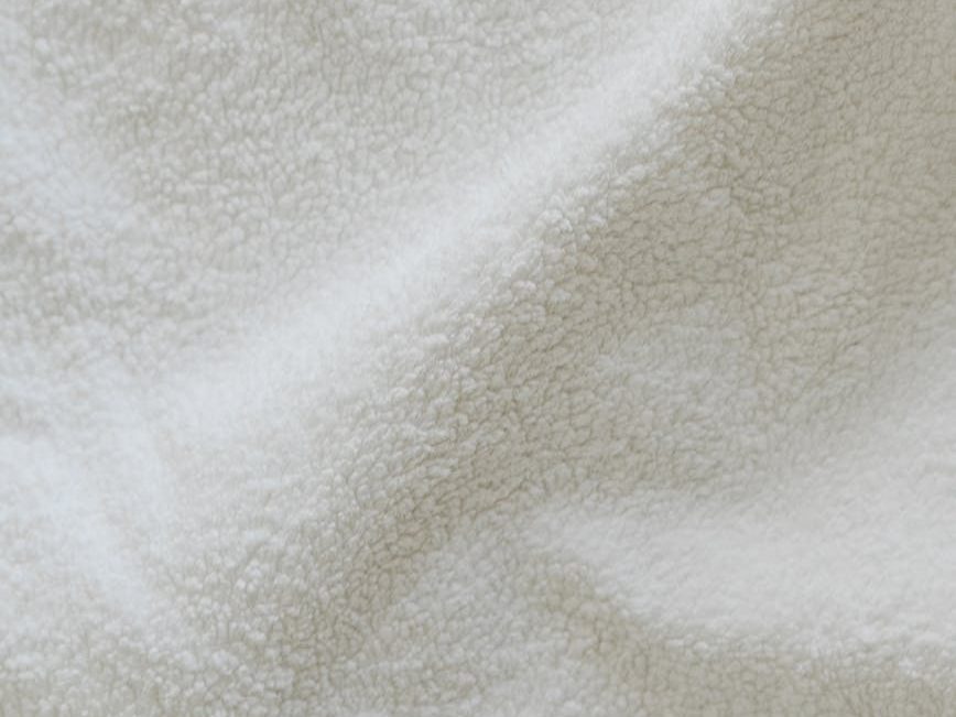 Placeholder image - close-up of shadows on fuzzy white textile 