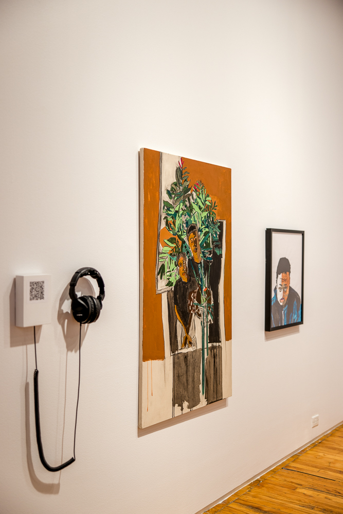 View of audio track and two paintings from an angle to the left of the works looking across them. 